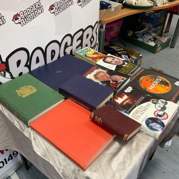 Collection of hardback reading material including The Doomsday Book on a table