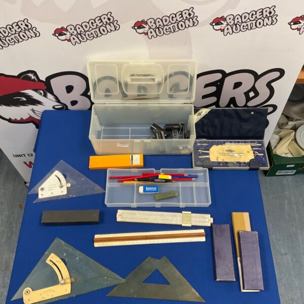 Vintage draughtsman's drawing set with slide rule, set squares and protractors on blue table