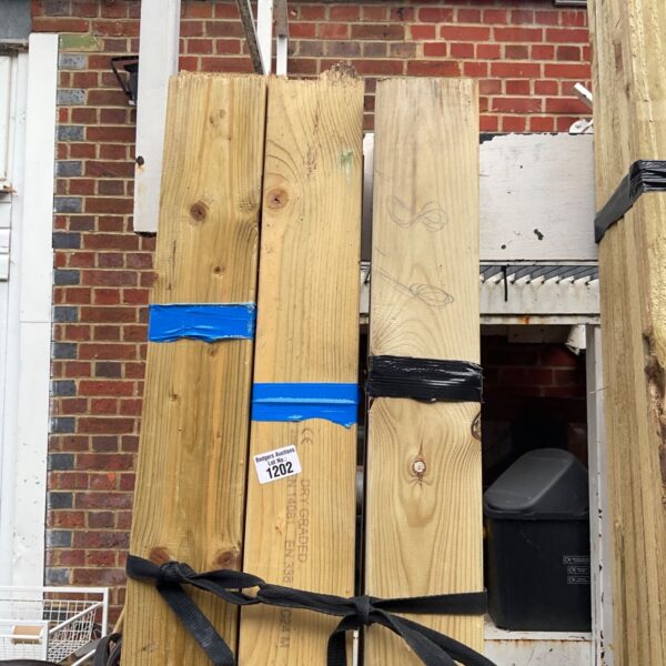 Three bundles of dry graded timber strapped together with tape