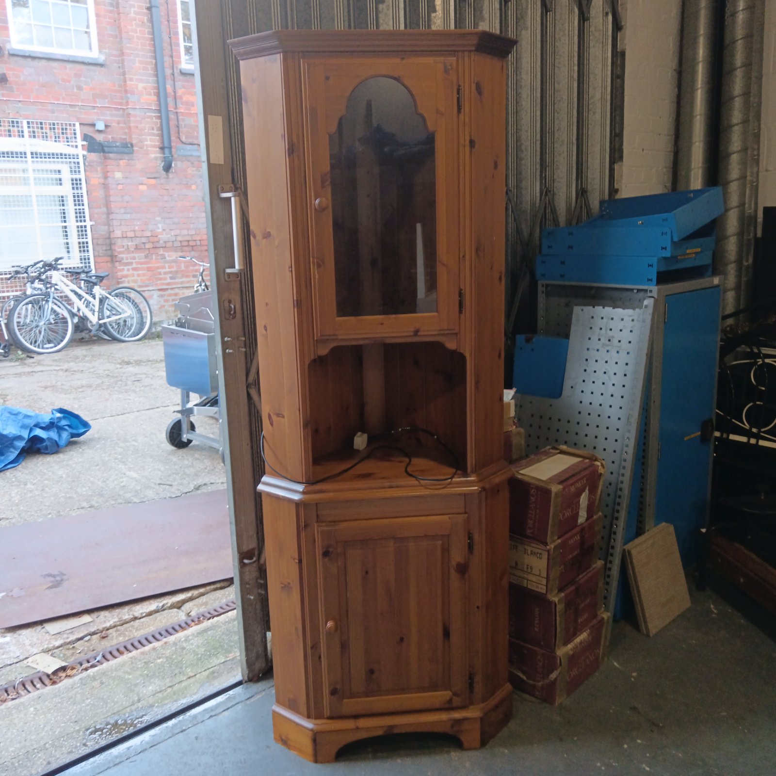 Ducal pine corner cabinet with glazed upper door and panelled base