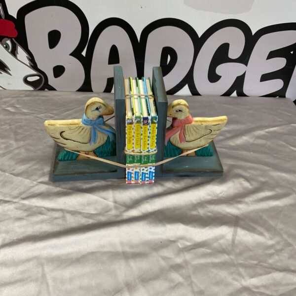 Painted wooden duck bookends holding Axel Scheffler children's books