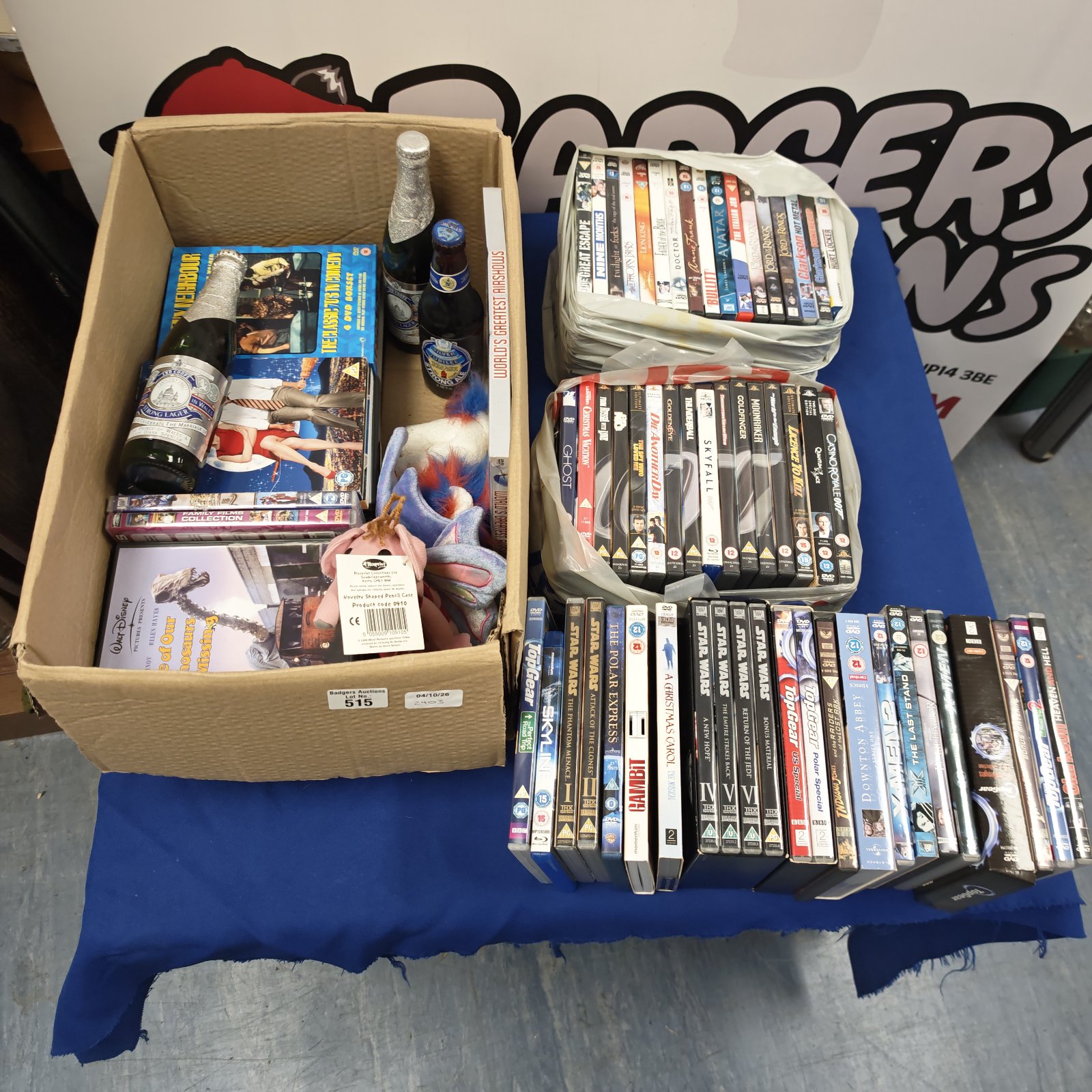 Mixed lot of DVDs and royal commemorative beers for collectors.