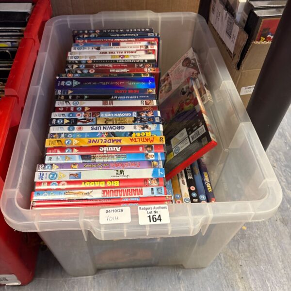 Mixed DVD movie lot with various film titles in a plastic container.