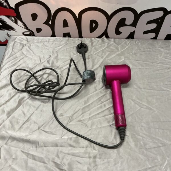 Fuchsia pink Dyson hair dryer with grey cable and UK plug