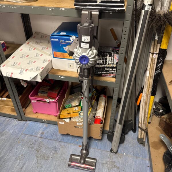 Dyson V6 cordless vacuum cleaner with charger included.
