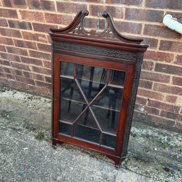 Edwardian inlaid mahogany corner cabinet with glazed door.