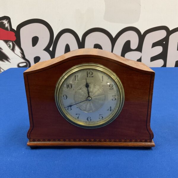 Front view of vintage French Edwardian style mantel clock with inlaid wooden case