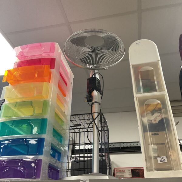 Silver electric pedestal fan with wire guard and round base