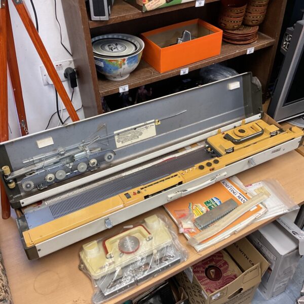 Vintage Empiral Knitmaster knitting machine with levers and needles.
