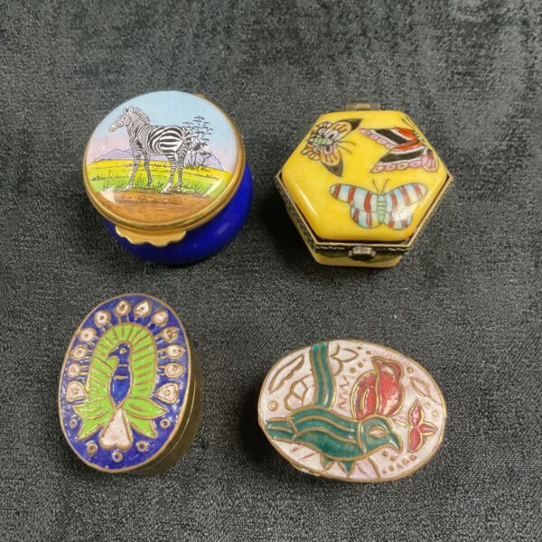 Antique enamel pill pots with floral designs, Victorian collectible.