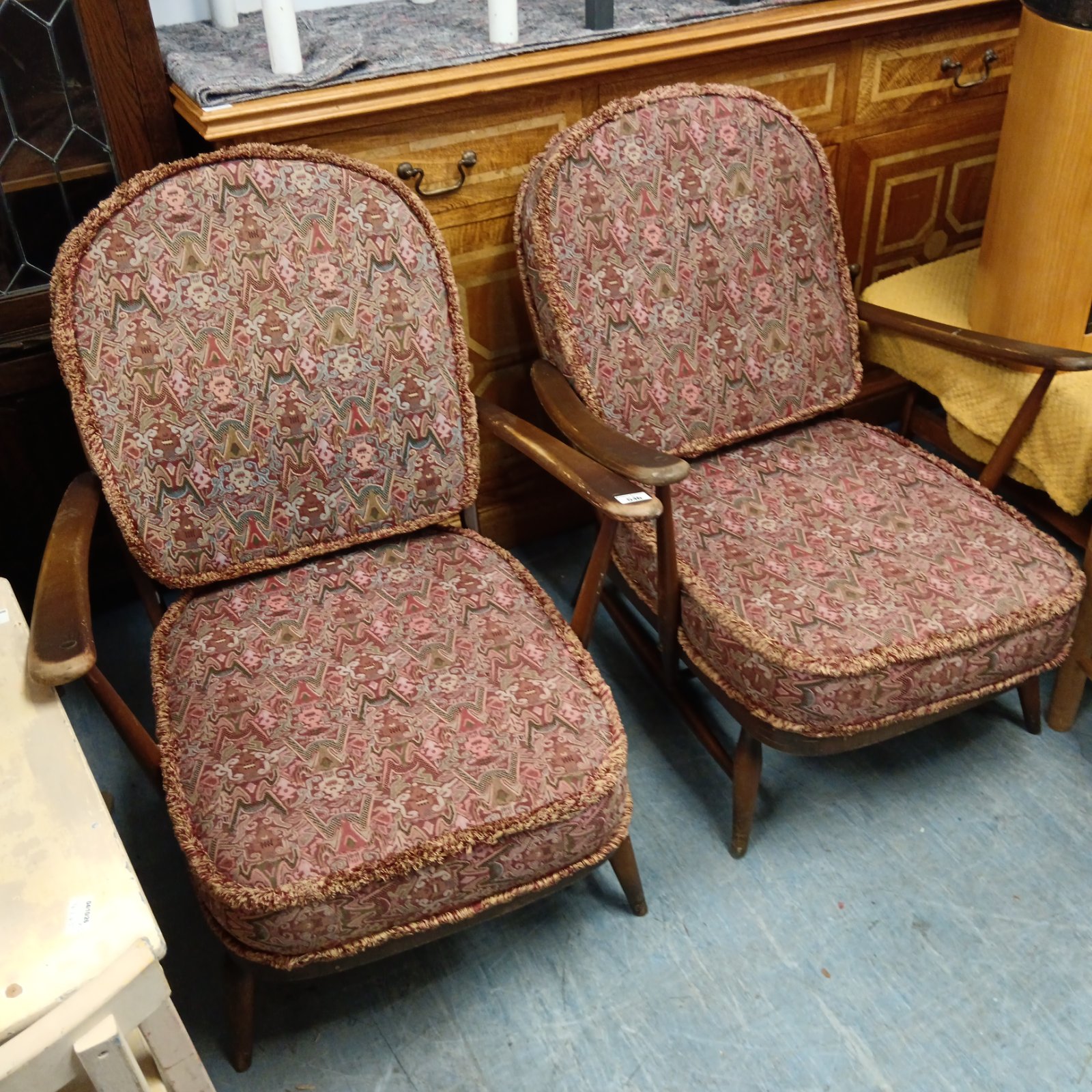 Vintage Ercol Low Rider armchairs in patterned fabric.
