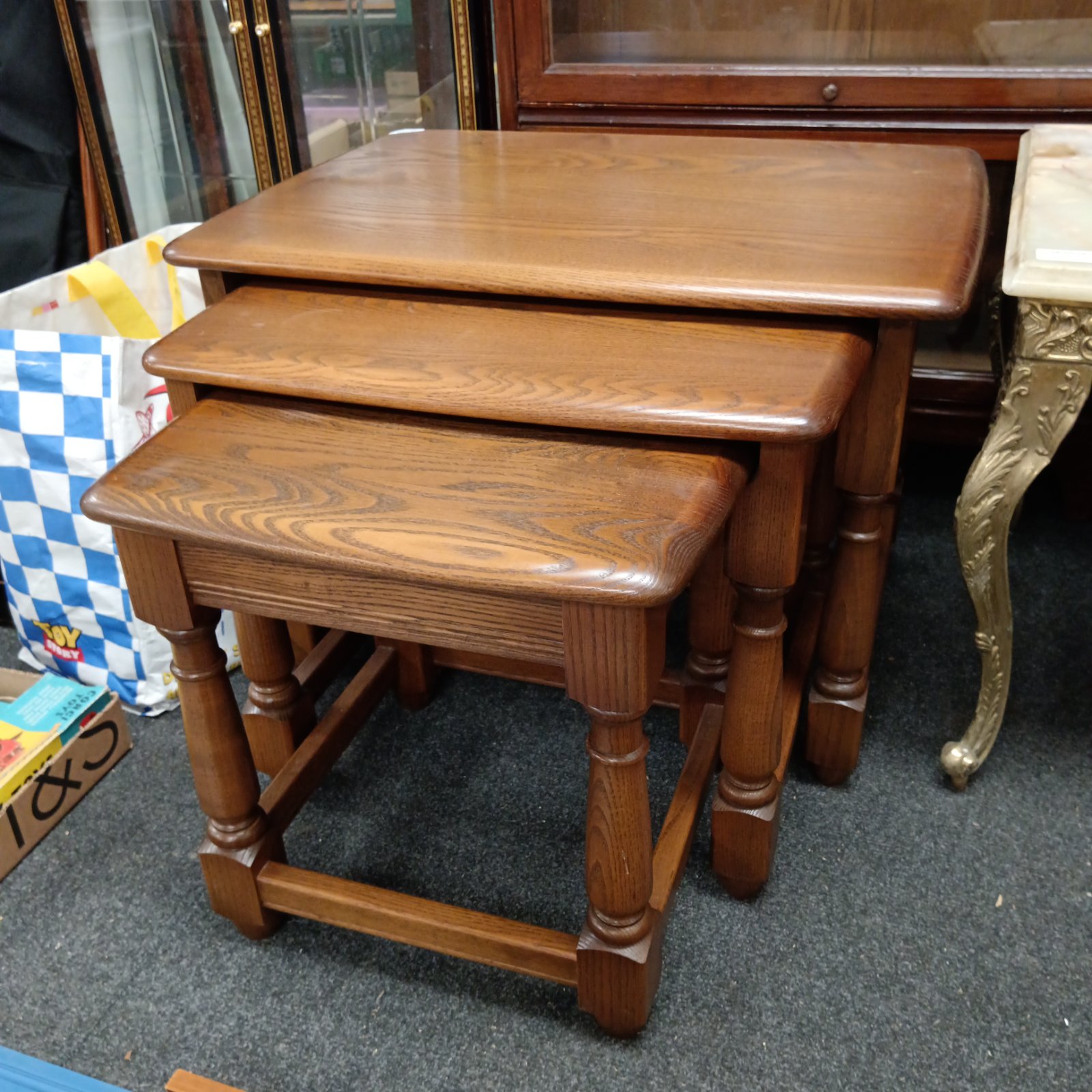 Vintage Ercol nest of three beech tables in good condition.
