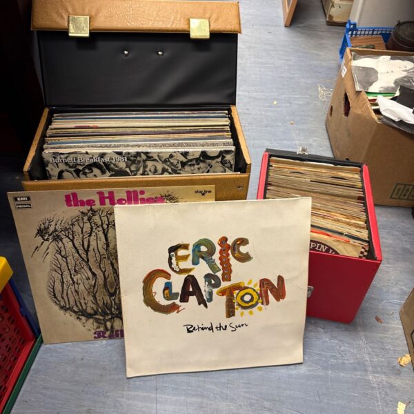 Mixed lot of Eric Clapton vinyl records in cardboard boxes.