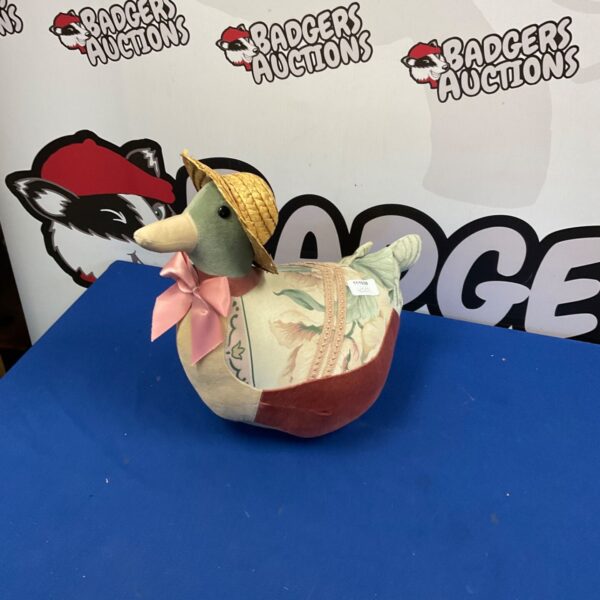 Handmade fabric duck doorstop with straw hat and patchwork design.