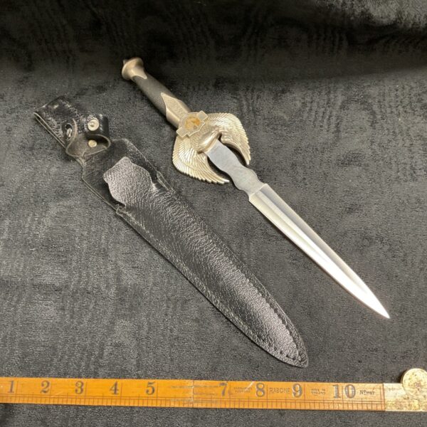 Fantasy dagger with winged handle and leather sheath.