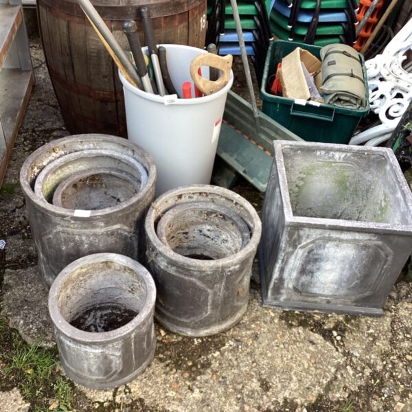 Lot of weathered fibreglass garden pots for outdoor planting.