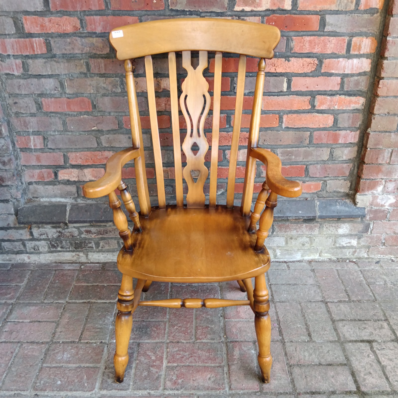 Traditional fiddleback armchair in a farmhouse style.