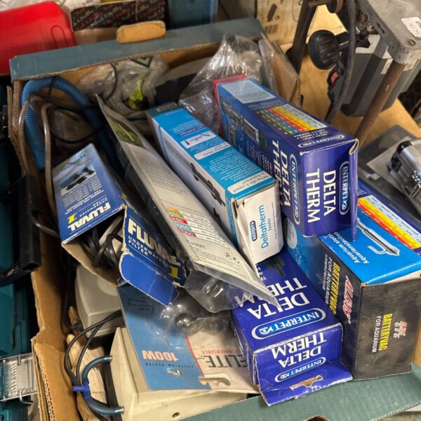 Assorted fish tank equipment including a Tetra heater in a box.