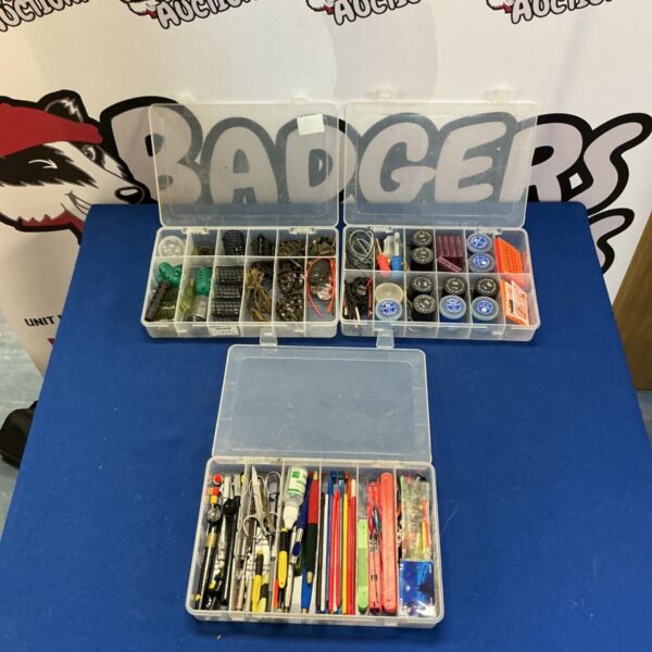 Three boxes filled with assorted fishing tackle and lures.