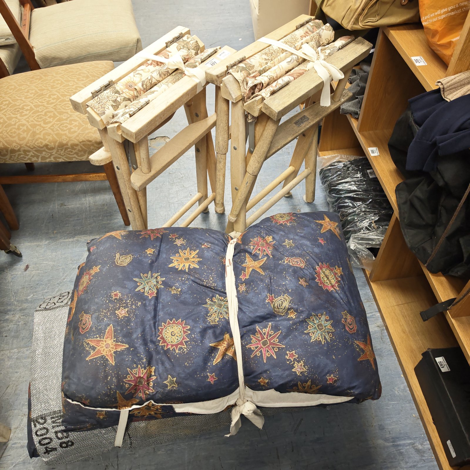 Floral director chairs with star pattern cushions for garden seating.