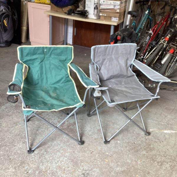 Pair of used folding camp chairs for outdoor use.