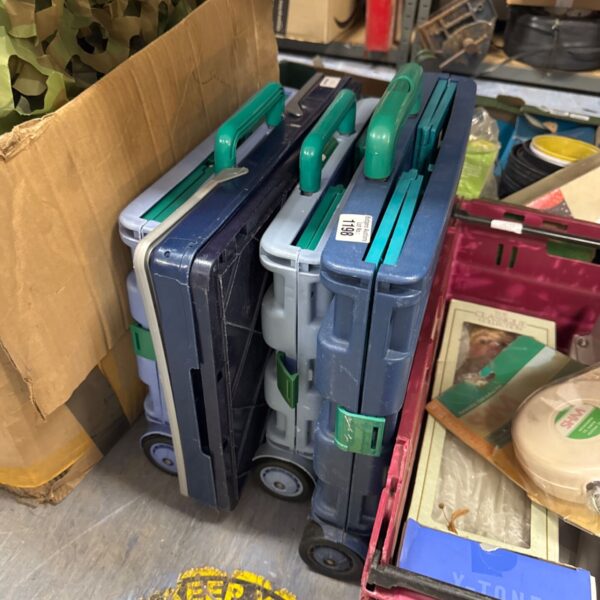 Four wheeled folding crates with telescopic handles for storage.