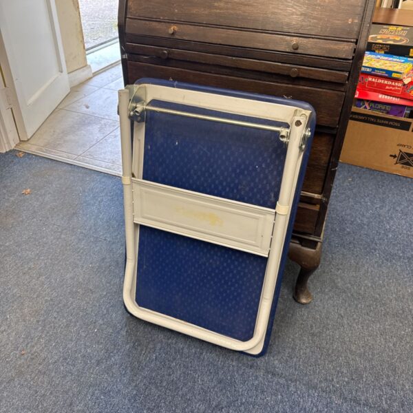 Folding metal trolley with blue textured panel and cream painted frame