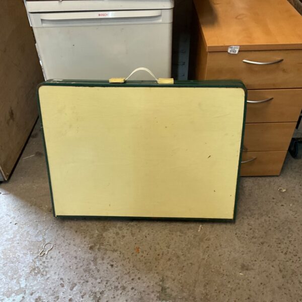White folding table with laminate surface, ideal for portable use.