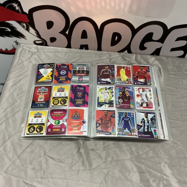Open binder pages displaying Topps Match Attax and Panini Adrenalyn football trading cards