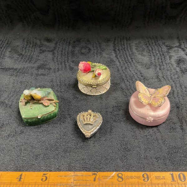 Four enamel trinket pots including bird, rose and butterfly designs