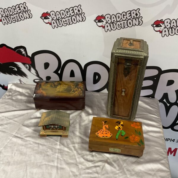 Four vintage wooden storage boxes displayed together on a light cloth
