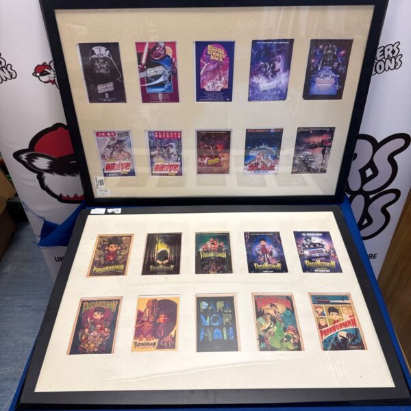 Two framed miniature movie poster displays showing Empire Strikes Back and ParaNorman posters