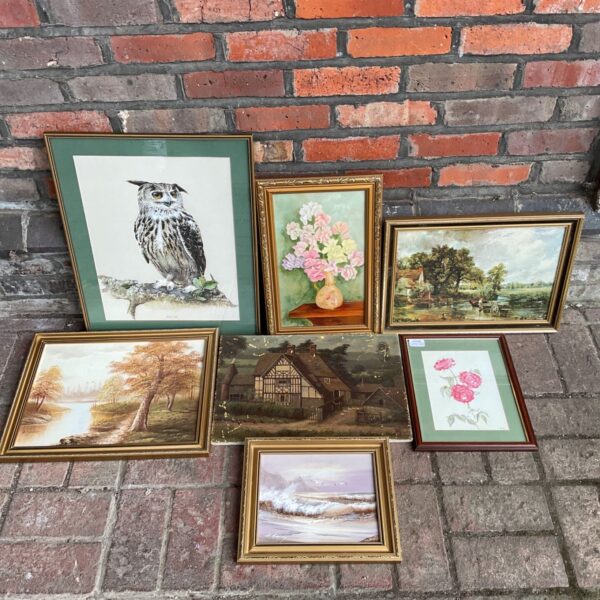 Collection of framed paintings including seascape and still life.
