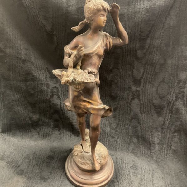 Vintage French bronze sculpture of woman with fruit basket.