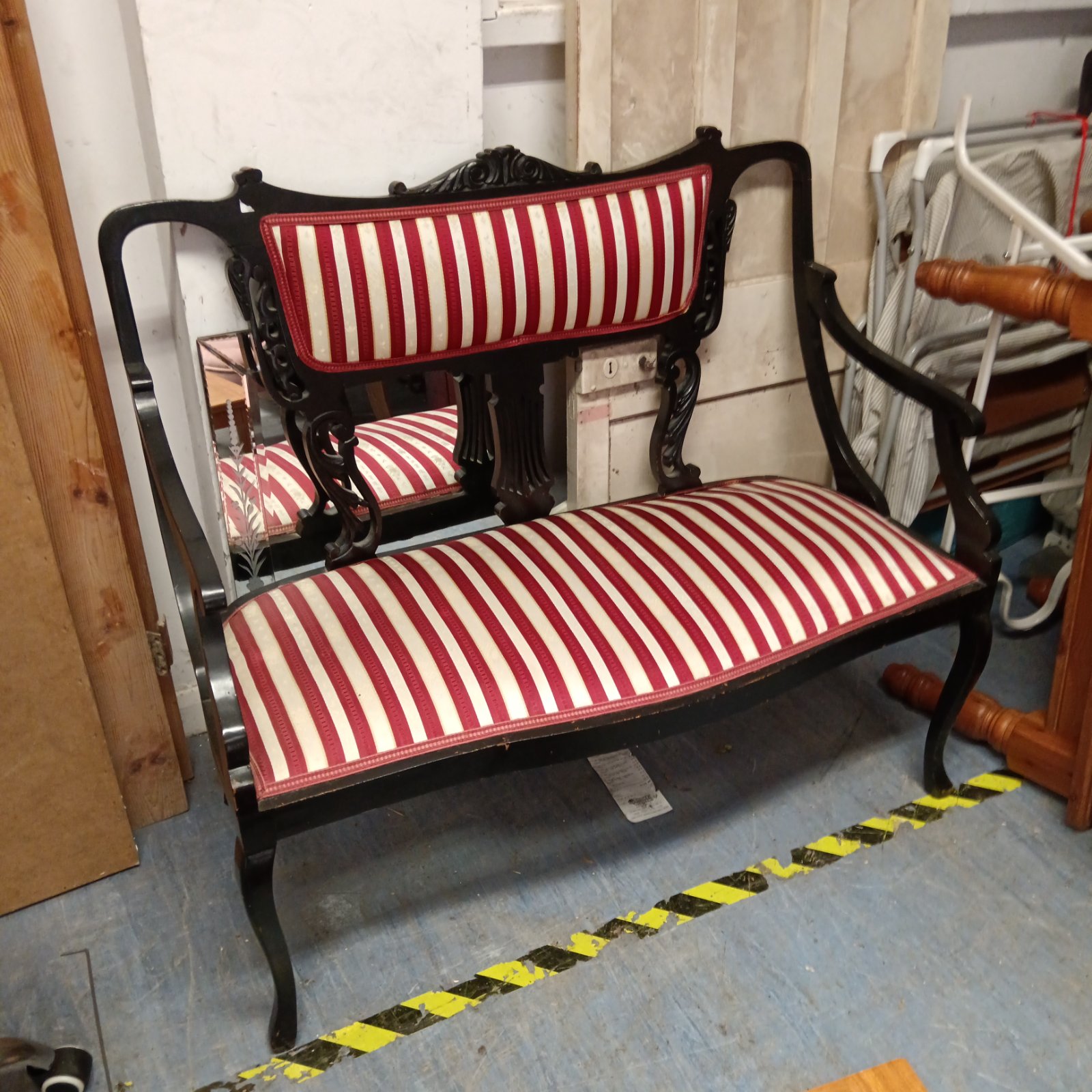 Vintage French parlour sofa with red and white striped upholstery.