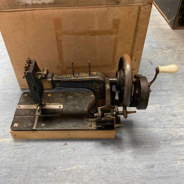 Antique Frister & Rossman hand crank sewing machine, detailed view.