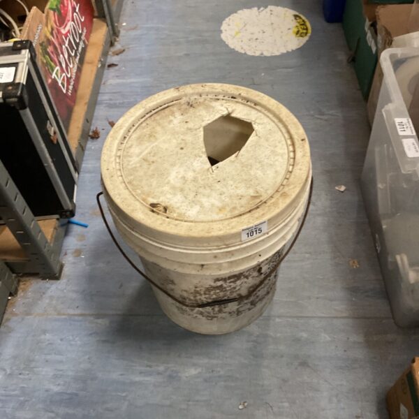 Grey garden bucket filled with metal fencefix U brackets.