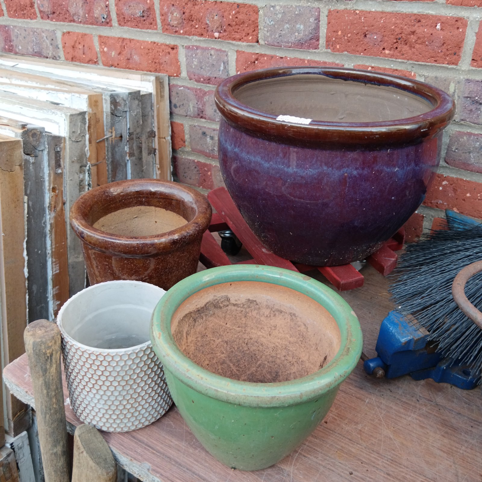 Collection of four vintage garden plant pots in various materials.