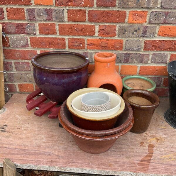 Assorted vintage garden pots and planters for outdoor use.