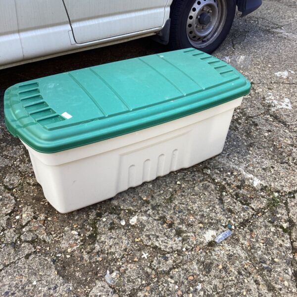 Large plastic garden storage box in an outdoor setting.