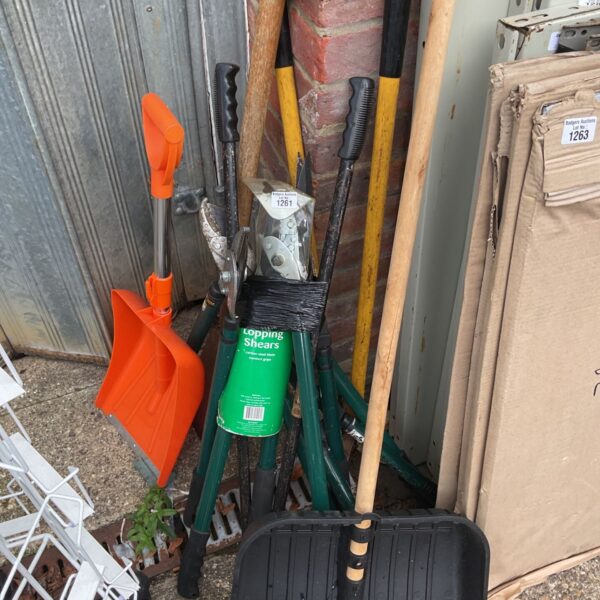 Bundle of used garden tools including shears, trowel and fork.