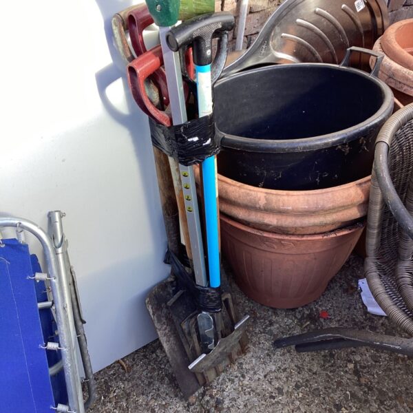 Assorted garden tools including a spade, fork and rake.