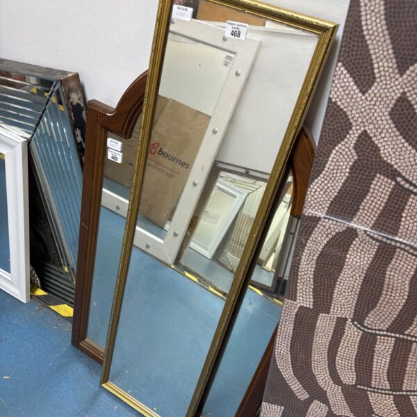 Antique gilt framed dressing mirror with ornate detailing.