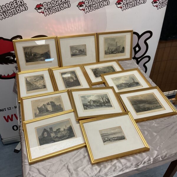 Collection of twelve gilt framed engravings displayed on a draped table
