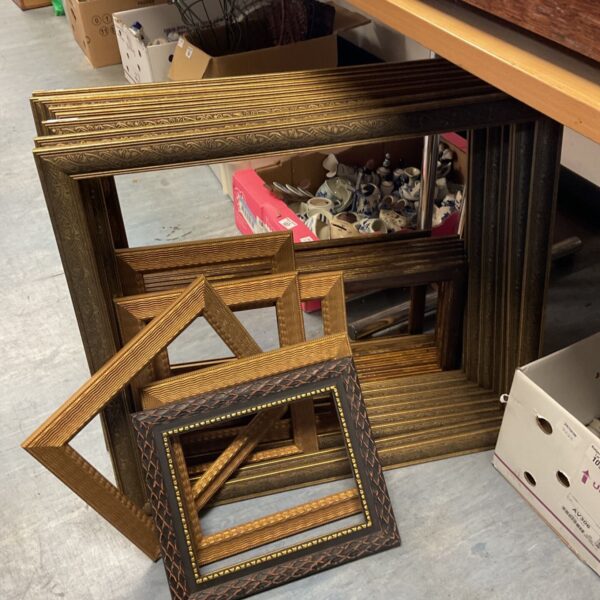 Large lot of various sized gilt and decorative picture frames stacked together