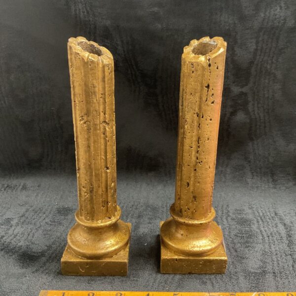 Antique gilt stone candlesticks, a decorative pair with golden finish.