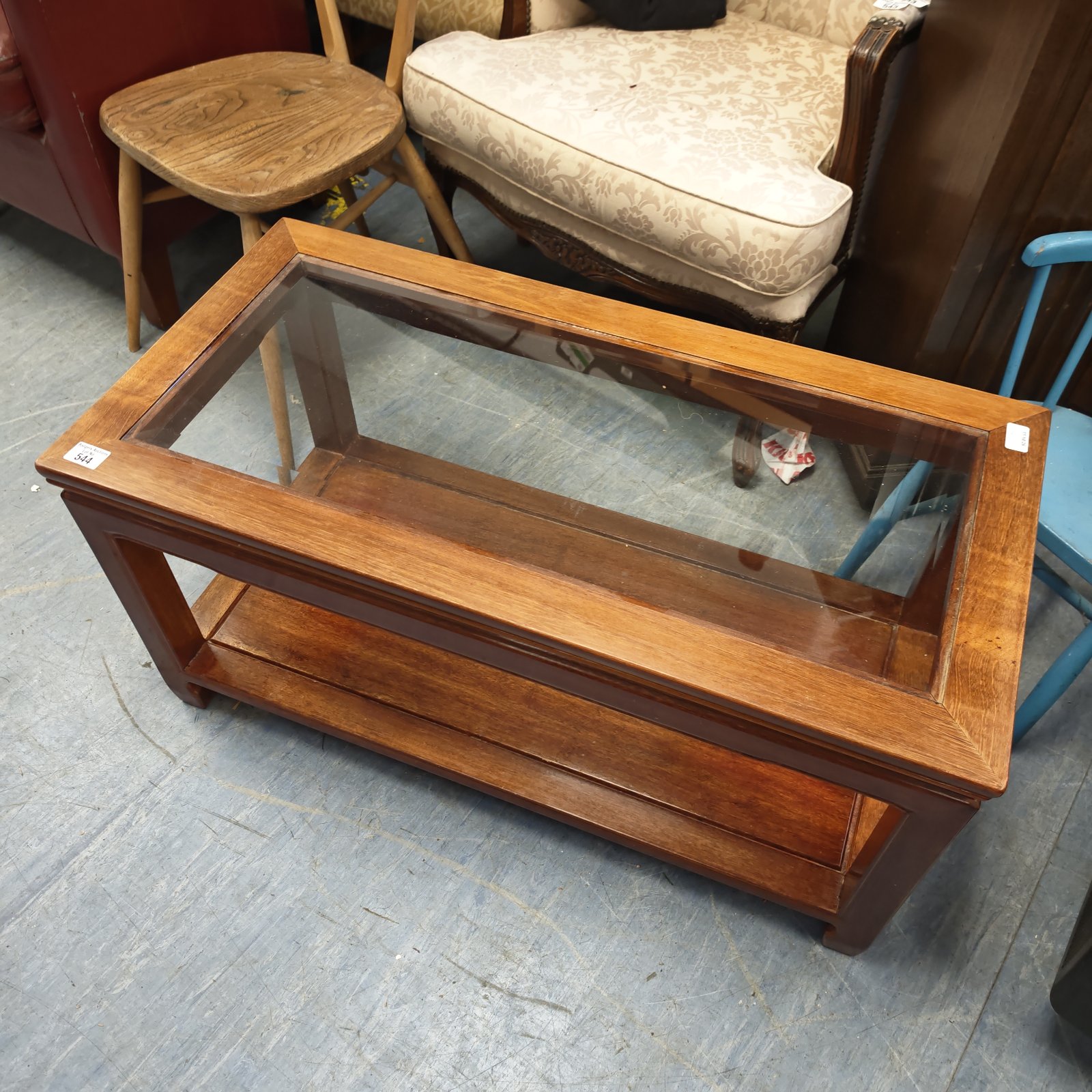 Vintage glass top coffee table with wooden frame.