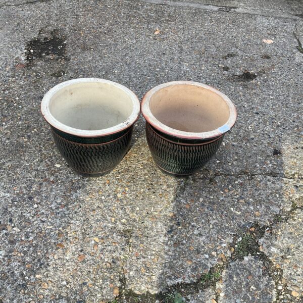 Pair of dark green glazed garden planters for outdoor use.
