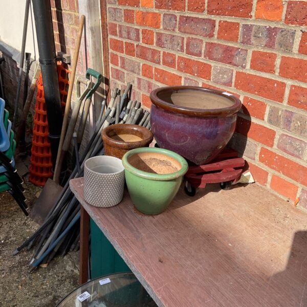 Three glazed garden pots displayed with a garden trolley.
