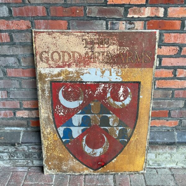 Large vintage Goddard Arms metal pub sign with heraldic crest.